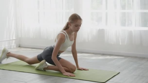 Young Woman Practicing Exercise Yoga Mat While Workout Stretching Leg — Stockvideo