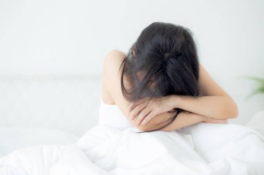 Young asian woman is depression and having mental problem sitting on bed in the bedroom at home, emotion and negative, woman loneliness and worry with disappoint, expression, lifestyles concept.