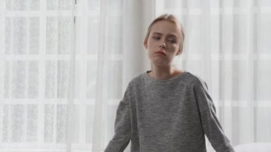 Young caucasian woman depressed while friends encourage in the bedroom at home, relation and assistance with cheering while unhappy and worried, lifestyles and feeling emotion with consoling concept.