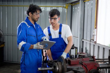 Supervisor training with young man sanding or iron at industrial factory, mechanic working job while polish metal, male having skill built steel with tool, labor and steelworks, industry concept.