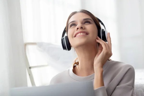 Happy Young Woman Wearing Headphones Listening Music While Using Laptop — Stock Photo, Image