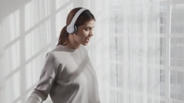 Happy Young Woman Wearing Headphones Listening Music While Dancing Singing — Vídeo de Stock