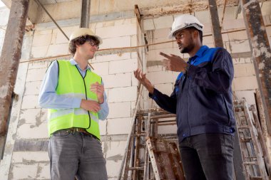 Architect and builder talking and inspector construction at construction site, contractor and worker discussion and planning strategy about progress infrastructure of real estate, engineer concept.