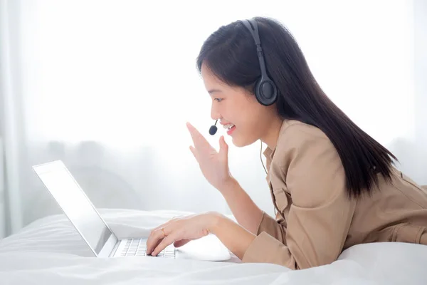 Young asian woman using laptop computer for video conference distance with online to friends, businesswoman working with video call for meeting with social network, business and communication concept.