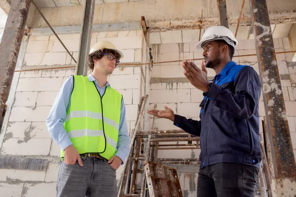 Architect and builder talking and inspector construction at construction site, contractor and worker discussion and planning strategy about progress infrastructure of real estate, engineer concept.