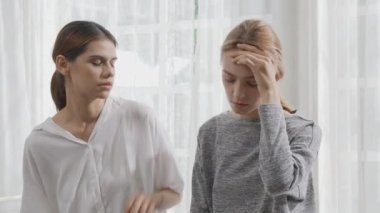 Young caucasian woman depressed while friends encourage in the bedroom at home, relation and assistance with cheering while unhappy and worried, lifestyles and feeling emotion with consoling concept.