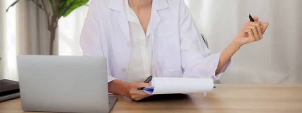 Young Woman Doctor Using Laptop Computer Looking Document Paper Patient — Stock Fotó