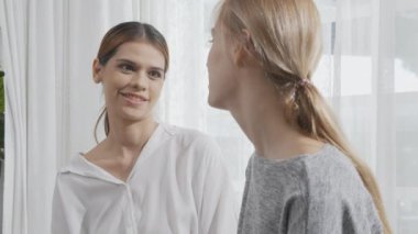 Young caucasian woman depressed while friends encourage in the bedroom at home, relation and assistance with cheering while unhappy and worried, lifestyles and feeling emotion with consoling concept.