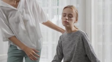 Young caucasian woman depressed while friends encourage in the bedroom at home, relation and assistance with cheering while unhappy and worried, lifestyles and feeling emotion with consoling concept.