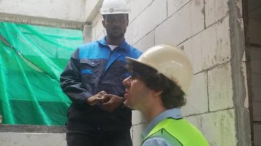 Architect and builder talking and inspector construction at construction site, contractor and worker discussion and planning strategy about progress infrastructure of real estate, engineer concept.