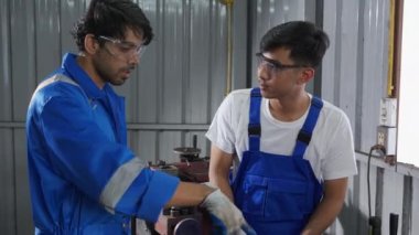 Supervisor training with young man sanding or iron at industrial factory, mechanic working job while polish metal, male having skill built steel with tool, labor and steelworks, industry concept.