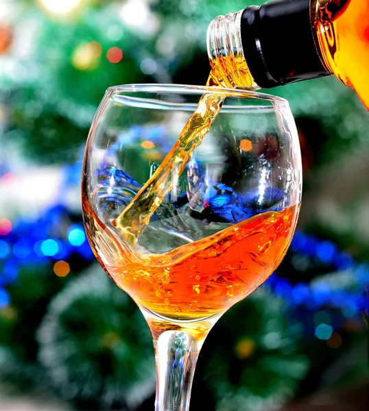 Brandy is poured into a glass — Stock Photo, Image