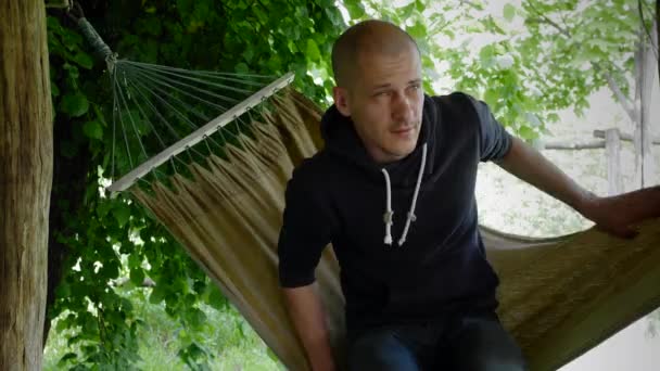 Stock Video Footage Thin Bald Caucasian Man Walks Hammock Lies — Stok video