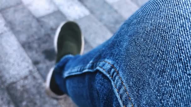 Man Jeans Sneakers Sits City Park Shakes His Leg Backdrop — Stock Video