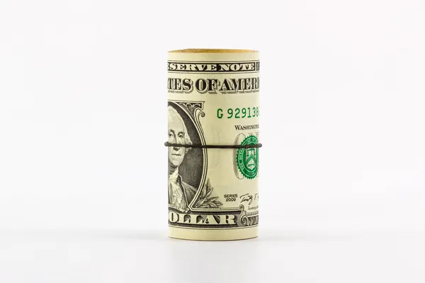 Banconote da un dollaro arrotolate con fascia di gomma . — Foto Stock