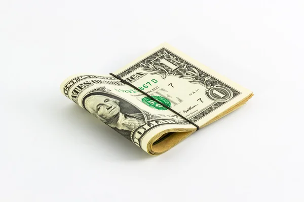 Banconote da un dollaro arrotolate con fascia di gomma . — Foto Stock