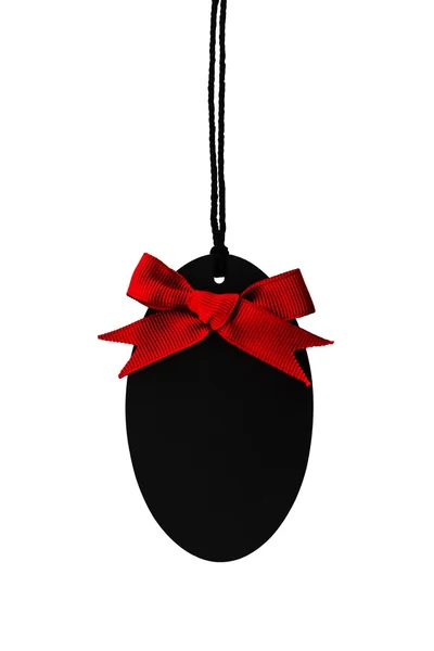 Black empty price label with red ribbon bow. — Stock Photo, Image