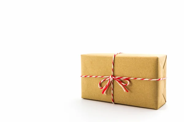 Cardboard carton wrapped with brown paper, tied with string. — Stock Photo, Image