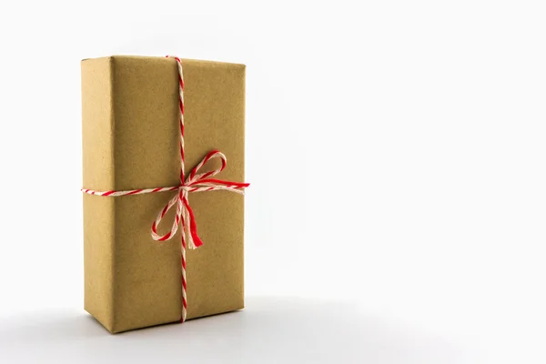 Cardboard carton wrapped with brown paper, tied with string . — Stock Photo, Image