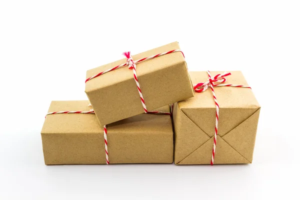 Cardboard carton wrapped with brown paper, tied with string. — Stock Photo, Image