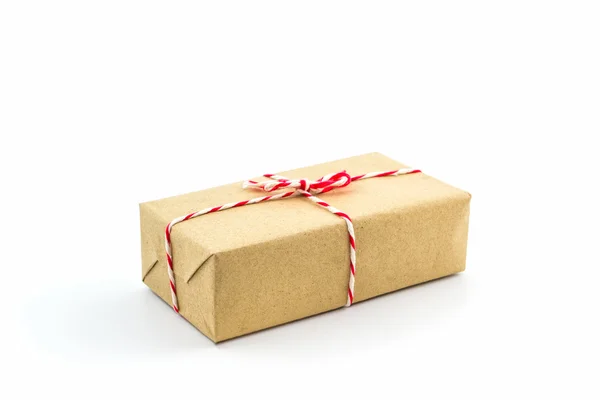 Cardboard carton wrapped with brown paper, tied with string. — Stock Photo, Image