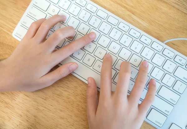 Kız klavyede yazı yazıyor.