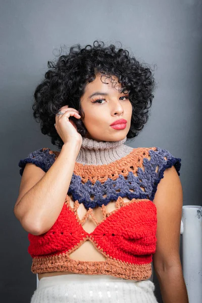 portrait of beautiful young Mexican woman with sensual lips and curly hair. skincare concept