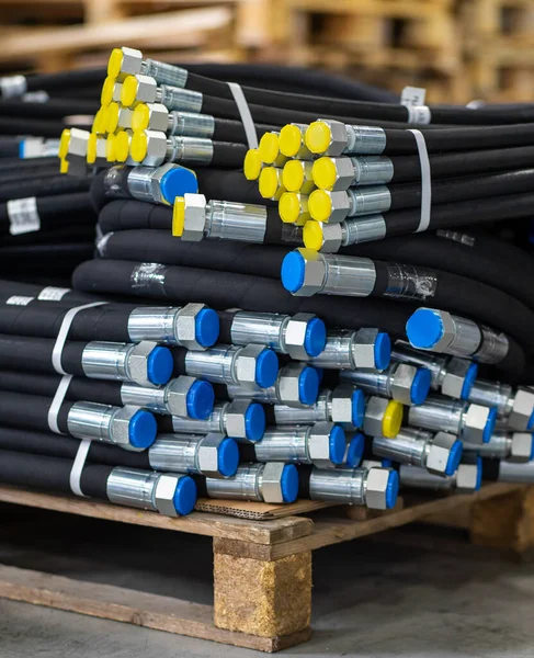 High pressure hydraulic hoses on a pallet. Packaged high pressure hydraulic hoses and ready for transport. Warehouse with hydraulic hoses