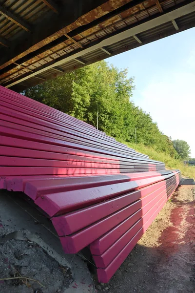 Pink stairs in the park overlooking the city under the rays of the sun