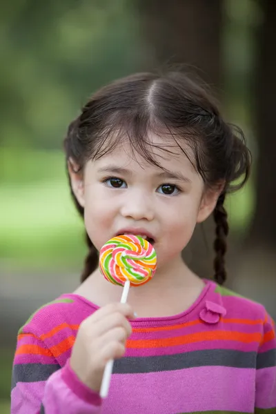 Littler girl enjoy with candy — Stock Photo, Image