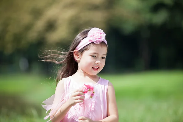 Little cute girl in pink dress hold wedding decoration — Stock Photo, Image