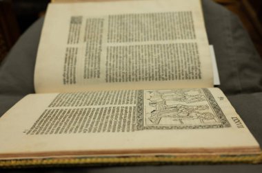 An open old book with a reduced focus and directed to the center