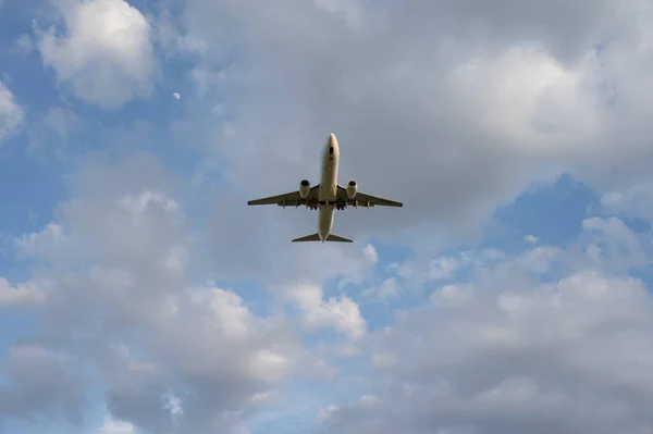 Beautiful panoramic background with flying plane in blue sky. The passenger plane with the landing gear taken off will take off in the sky. Travel concept. Wide angle stationery or web banner with copy space