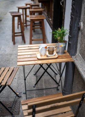 A table of a cafe with a glass of coffee and cup. breakfast on the street