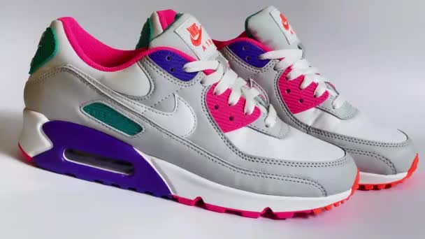 Kharkov, Ukraine - October 12, 2021: The famous Nike Air Max 90 sneakers on a white background. Iconic shoe with waffle sole, stitched overlays and classic thermoplastic accents and beautiful juicy — Stock Video