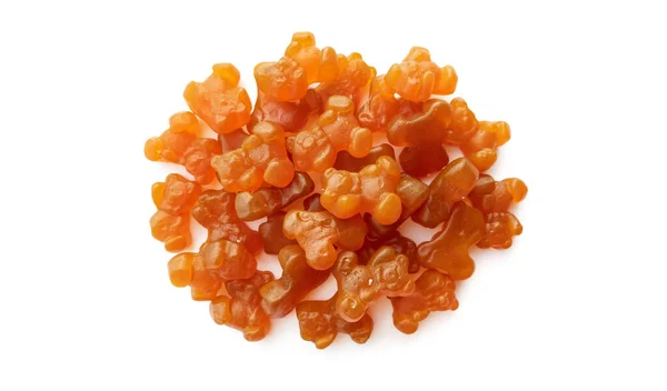 Close-up textuur van oranje en gele multivitamine gummies in de vorm van beren op witte achtergrond. — Stockfoto