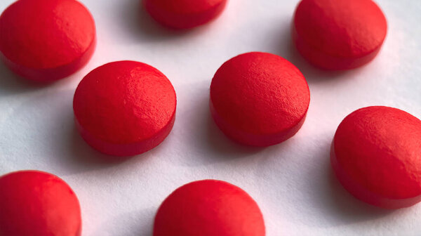 Selective focus, group of red medical pills isolated on white background.Health and medicine concept