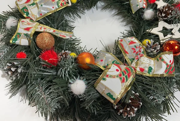 Χριστουγεννιάτικο στεφάνι στολίζει την μπροστινή πόρτα για τις γιορτές από έλατο, ασημένια τόξα, αστέρια και μπάλες Χριστουγέννων που απομονώνονται σε λευκό φόντο — Φωτογραφία Αρχείου