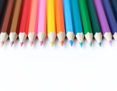 A set of colored pencils isolated on a white background in banner format. Place for text