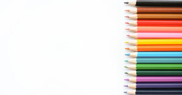 A set of colored pencils isolated on a white background in banner format. Place for text — стоковое фото