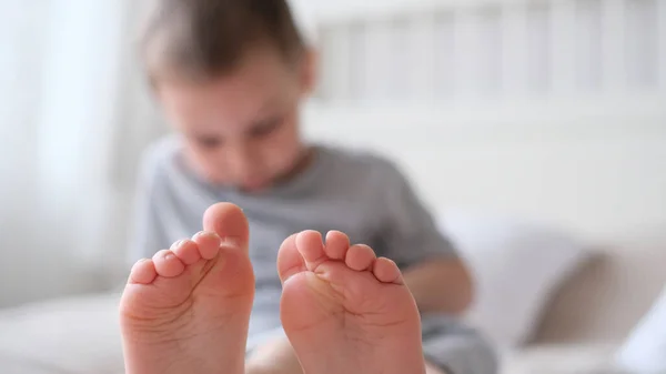 Close-up of childrens legs with feet forward — Stock Photo, Image