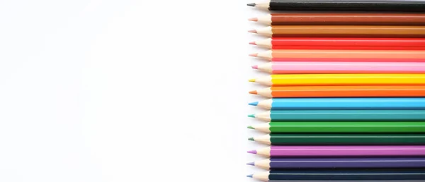 A set of colored pencils isolated on a white background in banner format. Place for text — стоковое фото
