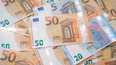 Arkaplanda farklı mezheplerden oluşan çok sayıda avro banknotları yer alıyor. Finans ve iş konsepti.