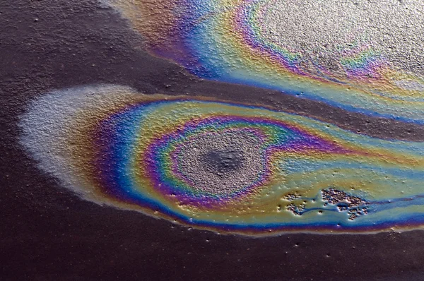 Iridescent spot of gasoline — Stock Photo, Image