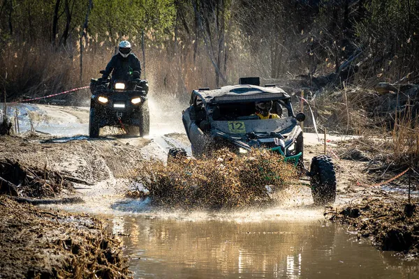 ATV and UTV riding in hard track with mud splash. Amateur competitions. 4x4.