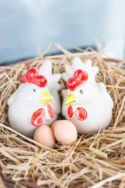 Chicken family ceramic on straw nest in straw nest