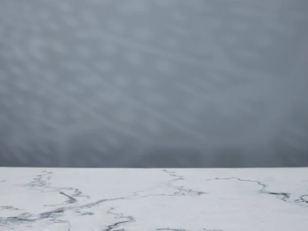 Marble table against a background of a concrete wall with natura