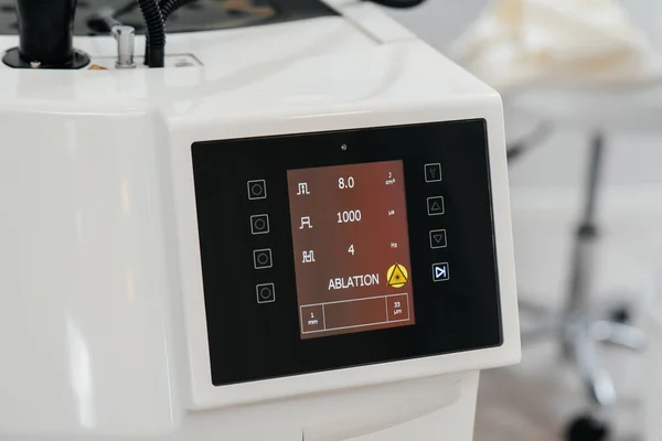 Modern laser in a beauty salon close-up. Laser pulses cleanse the skin. Hardware cosmetology. The process of photothermolysis, warming the skin. Facial skin rejuvenation.