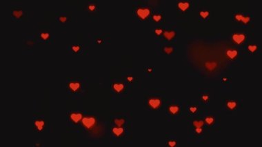 Döngü videosu. Karanlık arka planda soyut kırmızı kalpler. Konsept: Sevgililer günü, yıldönümü, anneler günü, evlilik, davetiye kartı. Kusursuz döngü 4k video.