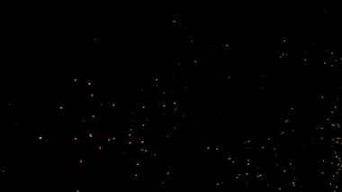 Gece gökyüzündeki büyük ateşten yanan kırmızı kıvılcımlar yükseliyor. Ateş, ışık ve yaşam temasının güzel soyut arkaplanı.